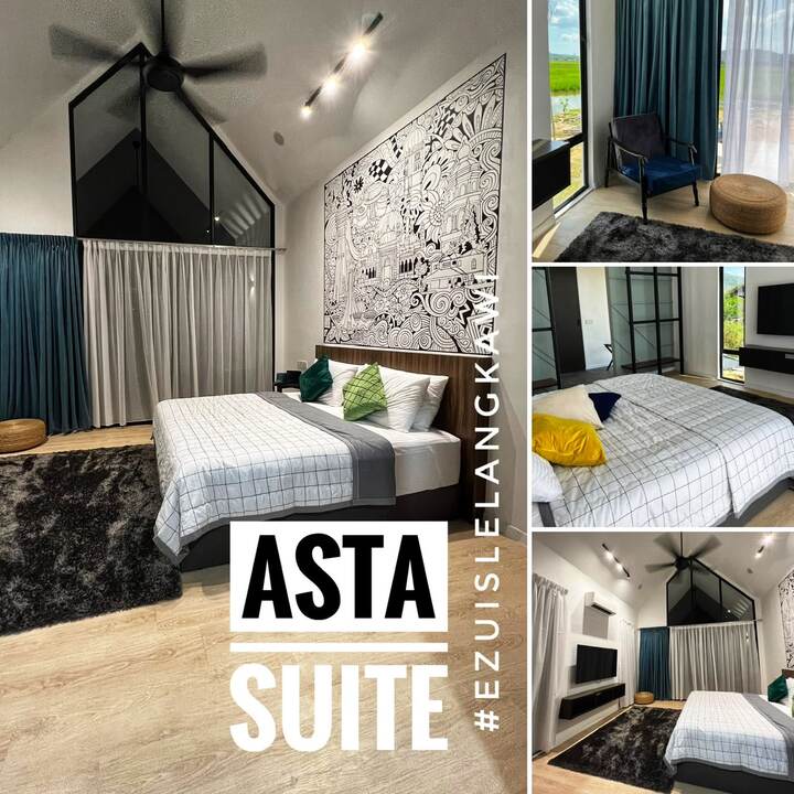 Asta Suite: king bed under a high A-frame ceiling with a black-and-white Malaysian landmark mural