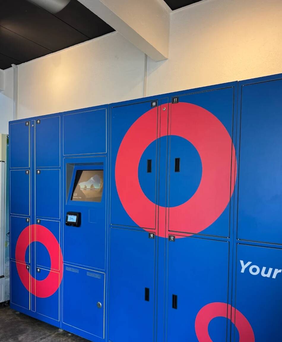 EZU2GO's blue left-luggage smart lockers with red rings, touchscreen kiosk in the centre
